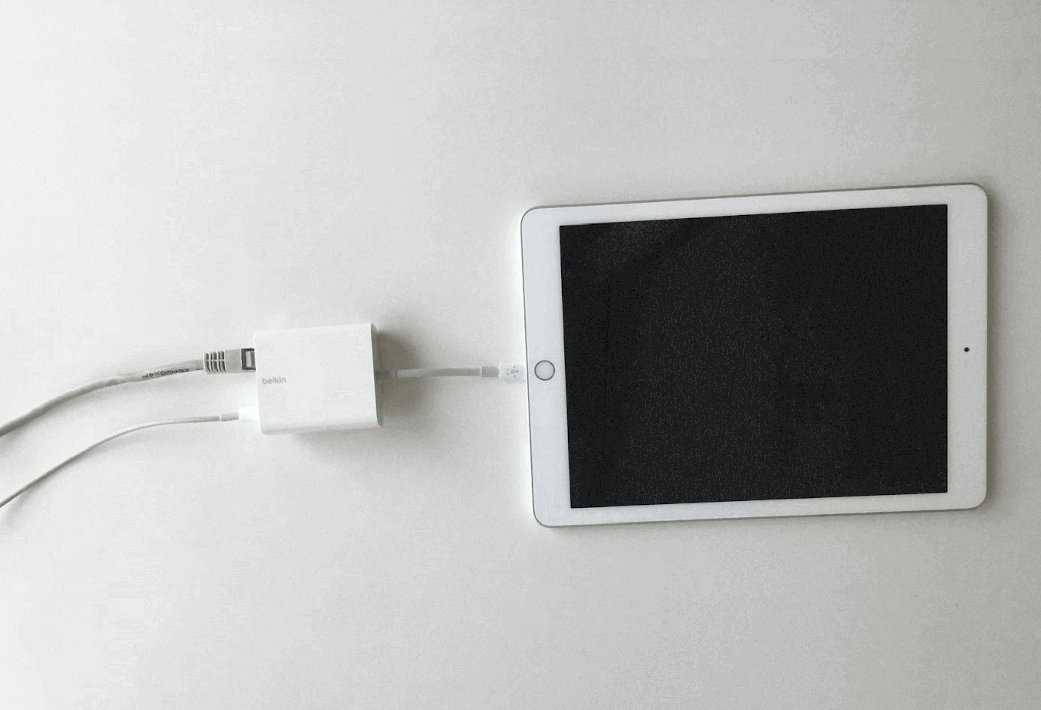 The Belkin adapter is plugged into the iPad.