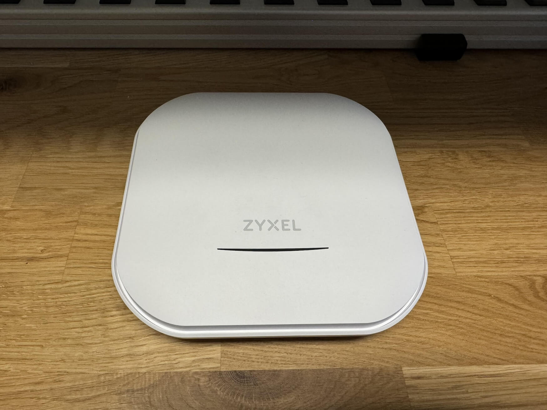 The Zyxel access point, sitting on a desk.