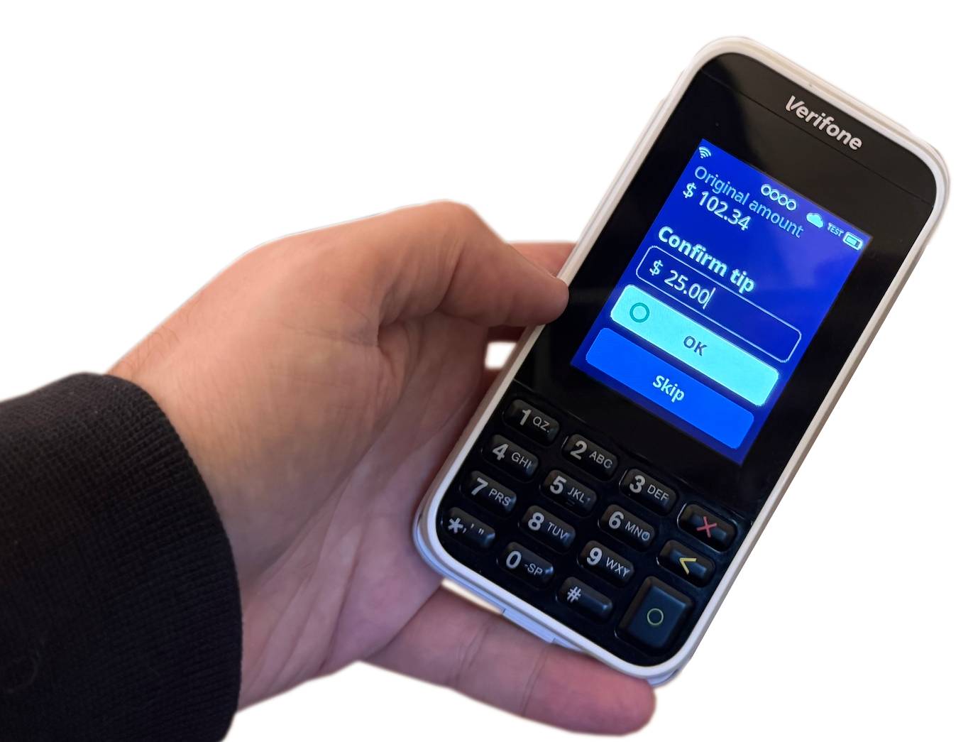 A customer pressing 'OK' to confirm their tip on a payment terminal.